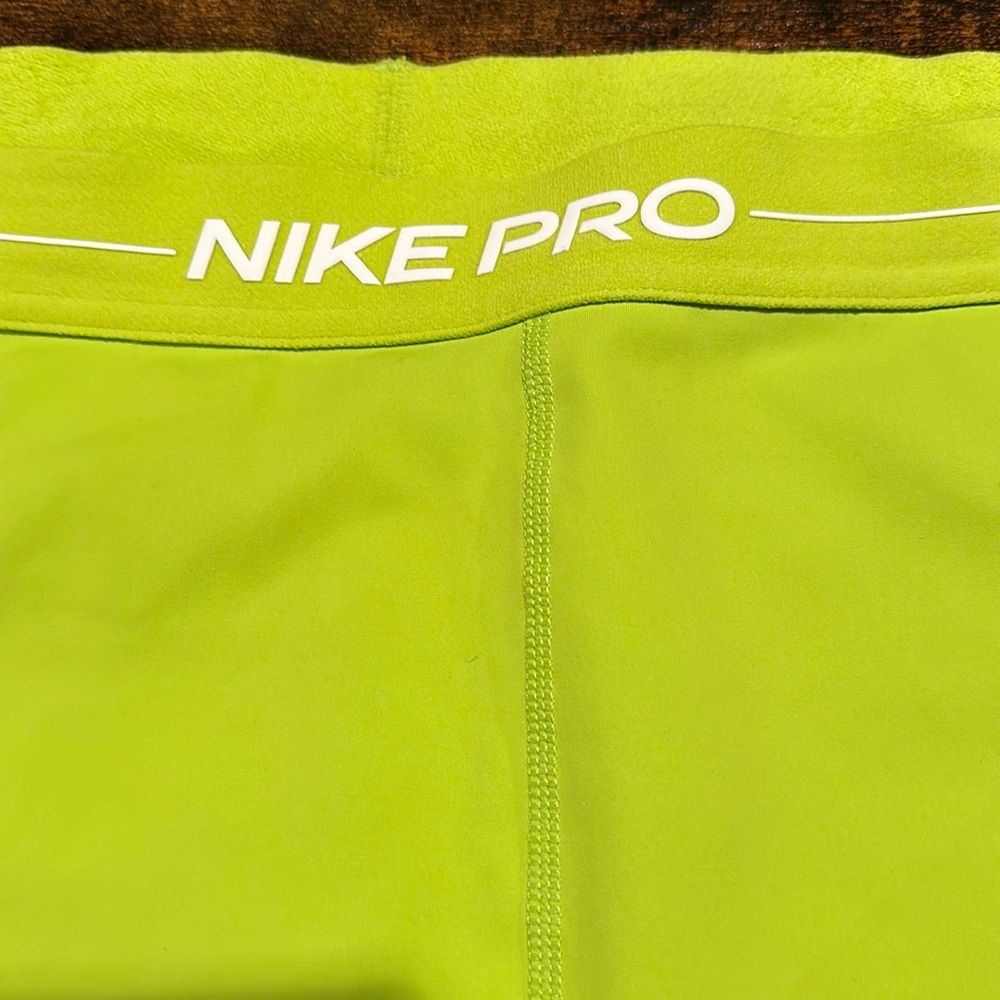 Nike pro green xxl fits more like  xl 
Compression style fabric .